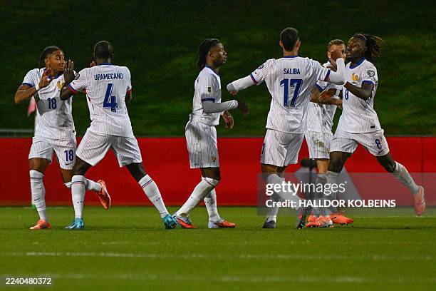 France's forward Christopher Nkunku celebrates scoring the 1-1 goal with his teammates during the 2026 World Cup qualifying round Group D football...