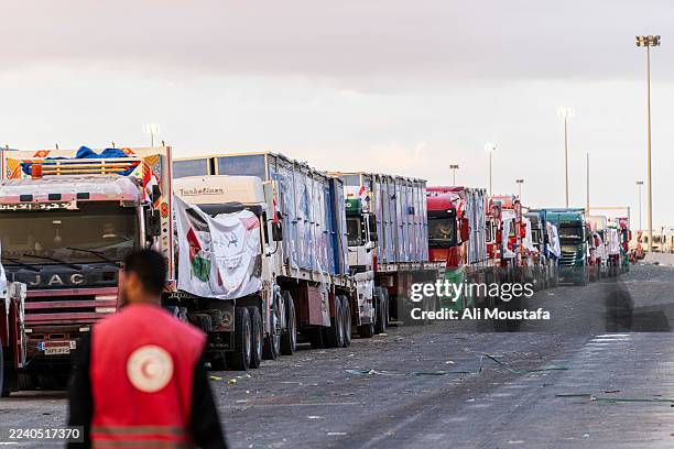 Trucks carrying aid wait at the border crossing for entry into the Gaza Strip on October 12, 2025 in Rafah, Egypt. This week's ceasefire deal between...