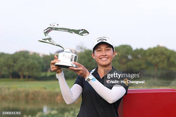 Jeeno Thitikul of Thailand poses with the trophy during the award ceremony after winning the final round of the Buick LPGA Shanghai 2025 at Shanghai...