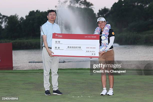 Jeeno Thitikul of Thailand poses for a photo with the winners cheque after winning the the final round of the Buick LPGA Shanghai 2025 at Shanghai...