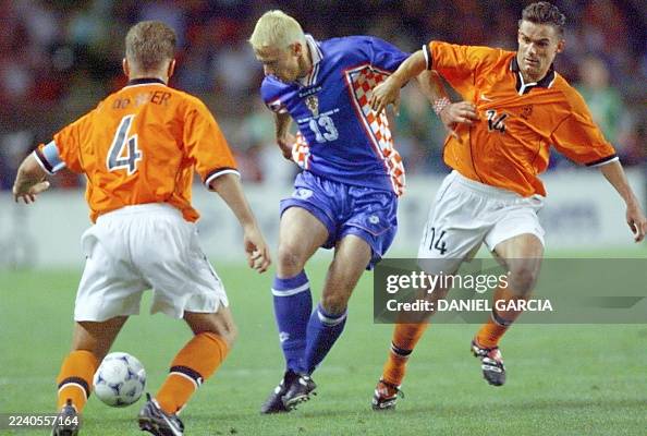Stanic Croatian midfielder Mario Stanic is caught between Dutch players ...