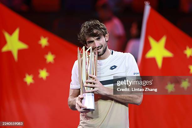 Valentin Vacherot of Monaco poses with his winner's trophy during medal ceremony after winning his match against Arthur Rinderknech of France in the...