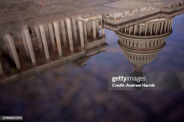 The Dome of the U.S. Capitol Building is visible in reflection on October 14, 2025 in Washington, DC. The government remains shut down after Congress...