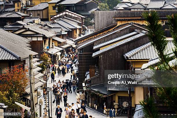 scenic street view featuring many people walking through historic kyoto japan - historic building stock pictures, royalty-free photos & images