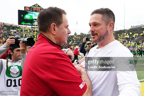Head coach Curt Cignetti of the Indiana Hoosiers and head coach Dan Lanning of the Oregon Ducks meet at midfield following a game at Autzen Stadium...