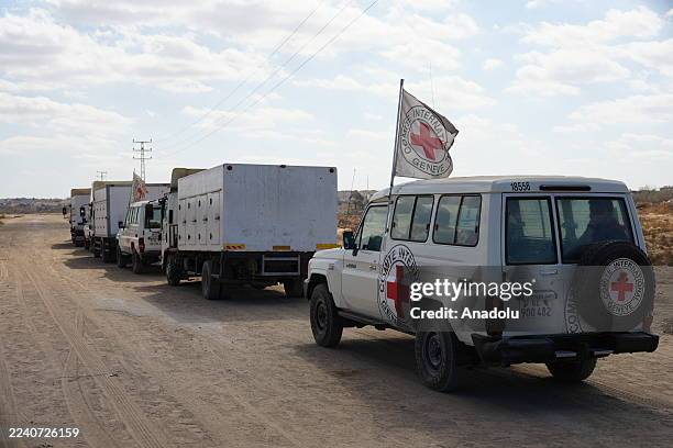 Members of the International Committee of the Red Cross wait near the Kisufim Border Gate in central Gaza to receive the bodies of around 60...