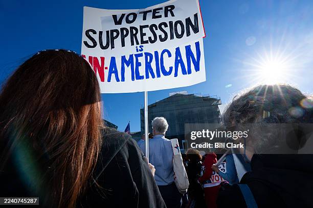 Voting rights activists protest outside the U.S. Supreme Court as the court prepares to hear arguments in a case challenging Louisiana's...