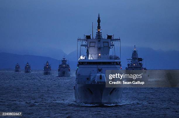 Ships of the German Navy, including the "Baden-Wuerttemberg" frigate , sail at twilight during the Andoya "Missile Firing Exercise 2025“ military...