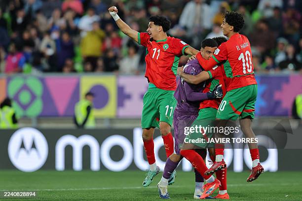 Morocco's goalkeeper Abdelhakim Mesbahi celebrates with teammates after saving the final penalty and securing victory in the shootout during the 2025...