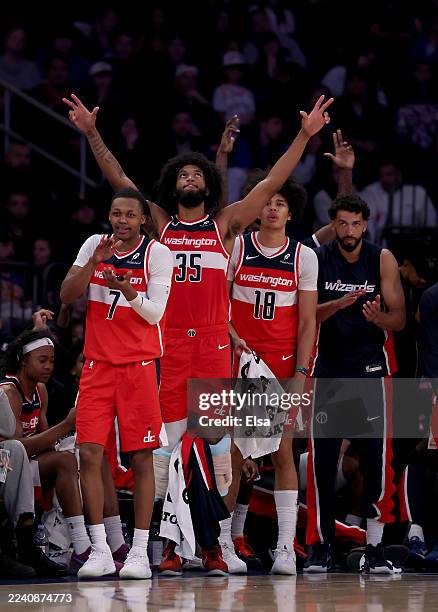 Bub Carrington, Marvin Bagley III and Kyshawn George of the Washington Wizards celebrate after teammate Tristan Vukcevic hit a three point shot...