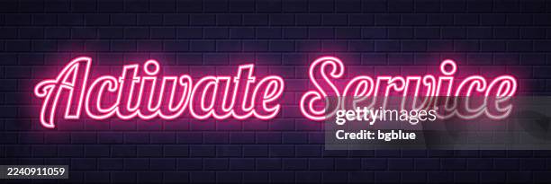 activate service - glowing neon text on brick wall background - pushing against wall stock illustrations