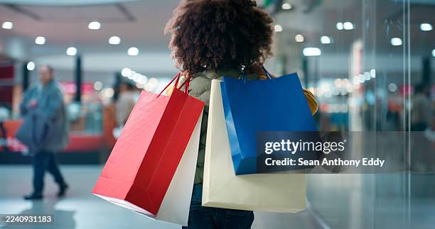 shopping, child and walking with bags in mall for discount deal, clearance sale and bargain offer. consumer, back of person and retail products for kid designer brand, black friday purchase and bokeh - clothing store stock pictures, royalty-free photos & images