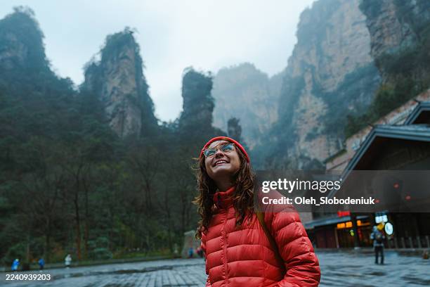 woman hiking in epic zhangjiajie forest park during trip to china in winter - zhangjiajie-national-forest-park stock pictures, royalty-free photos & images
