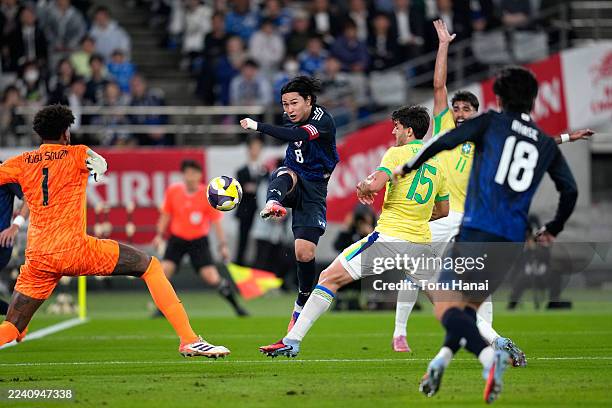 Takumi Minamino of Japan passes the ball during the international friendly match between Japan and Brazil at Tokyo Stadium on October 14, 2025 in...