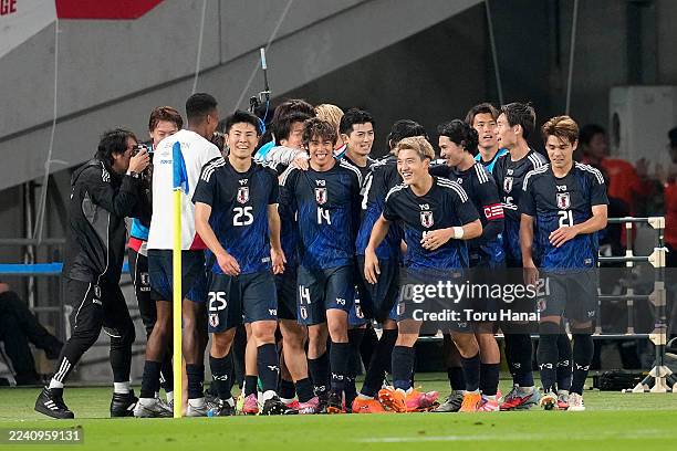 Ayase Ueda of Japan celebrates with teammates after scoring the team's third goal during the international friendly match between Japan and Brazil at...