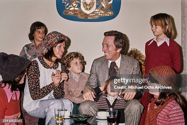 Franco-American singer, actress and dancer Claudine Longet, wearing a white knitted waistcoat over a patterned blouse and a knitted hat, and her...