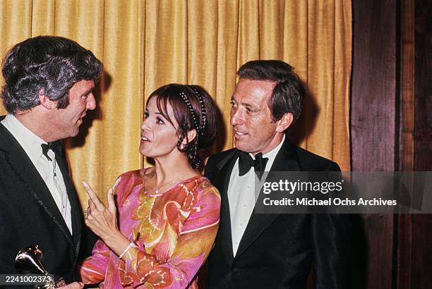 American composer, songwriter and pianist Burt Bacharach, wearing a tuxedo and bow tie, Franco-American singer, actress and dancer Claudine Longet,...