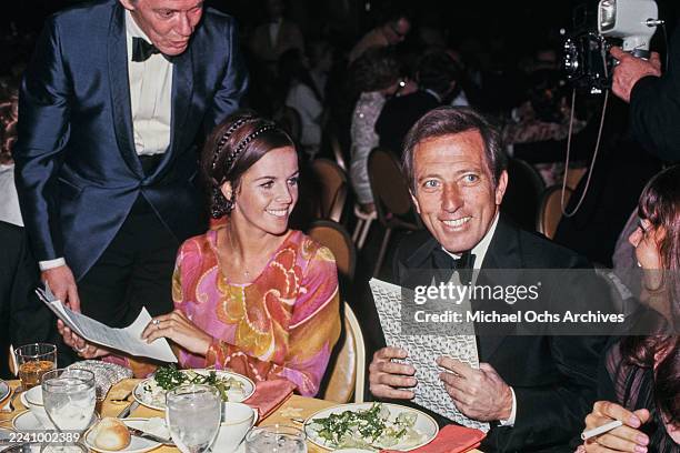 Franco-American singer, actress and dancer Claudine Longet, wearing a pink, yellow and red outfit, and her husband, American singer Andy Williams,...