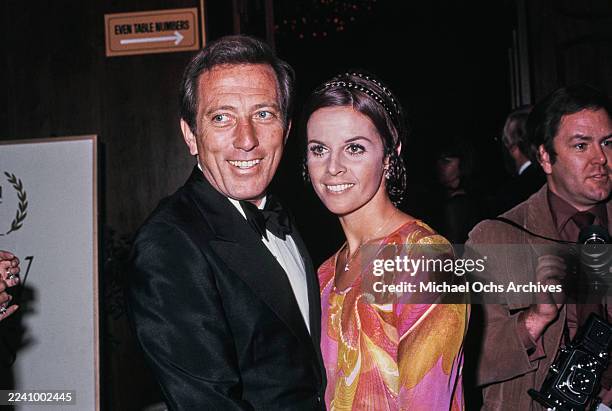 Franco-American singer, actress and dancer Claudine Longet, wearing a pink, yellow and red outfit, and her husband, American singer Andy Williams,...