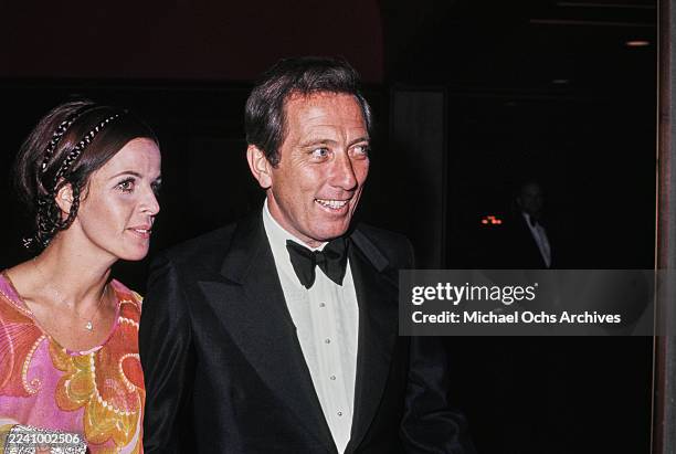 Franco-American singer, actress and dancer Claudine Longet, wearing a pink, yellow and red outfit, and her husband, American singer Andy Williams,...