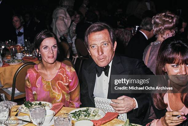 Franco-American singer, actress and dancer Claudine Longet, wearing a pink, yellow and red outfit, and her husband, American singer Andy Williams,...