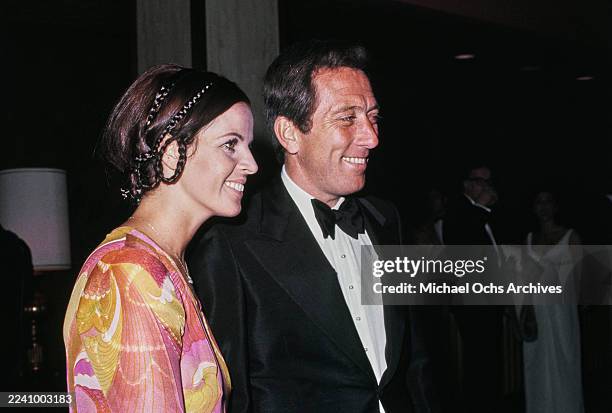 Franco-American singer, actress and dancer Claudine Longet, wearing a pink, yellow and red outfit, and her husband, American singer Andy Williams,...