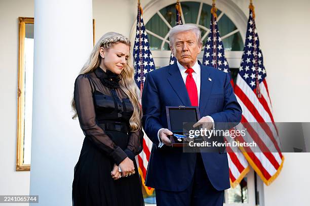 President Donald Trump posthumously awards the Presidential Medal of Freedom to late conservative activist Charlie Kirk as he presents the Medal to...