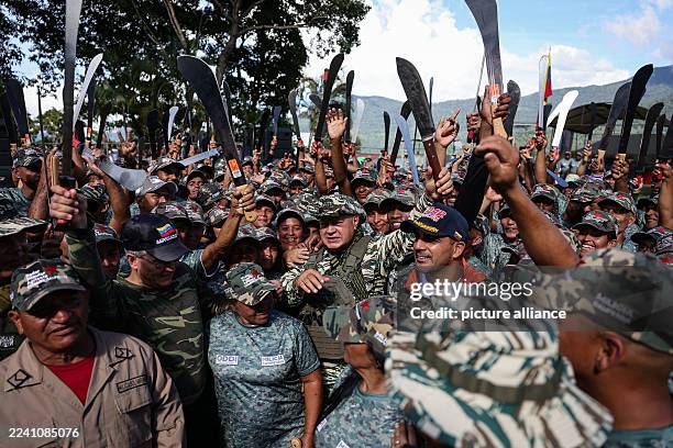 October 2025, Venezuela, La Guaira: Diosdado Cabello, Minister of the Interior and Justice, accompanied by militiamen during a swearing-in ceremony...
