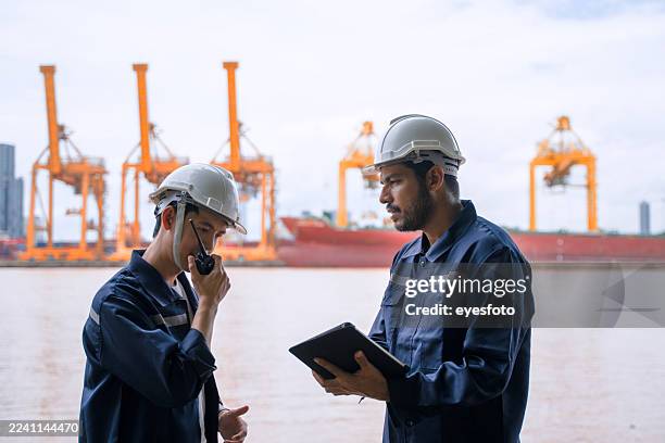 seaport workers are working at waterfront. - dock worker stock pictures, royalty-free photos & images