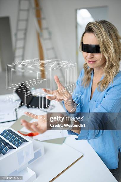 mature architect wearing virtual reality simulator examining house model - architect model stock illustrations