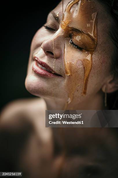 woman with liquid on face at health spa - aromaöl stock-fotos und bilder