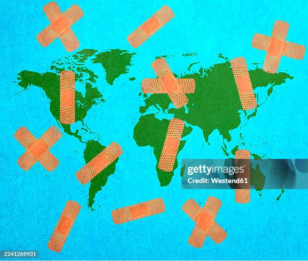 conceptual illustration of world map with sticking plasters representing global crisis - world problems stock illustrations