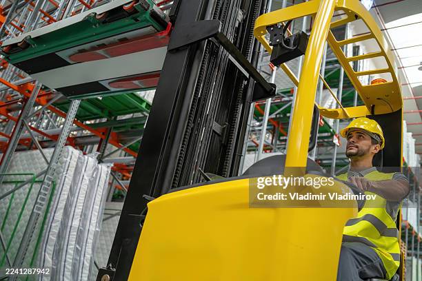 professional forklift operator handling warehouse tasks expertly. - mattress protector stock pictures, royalty-free photos & images