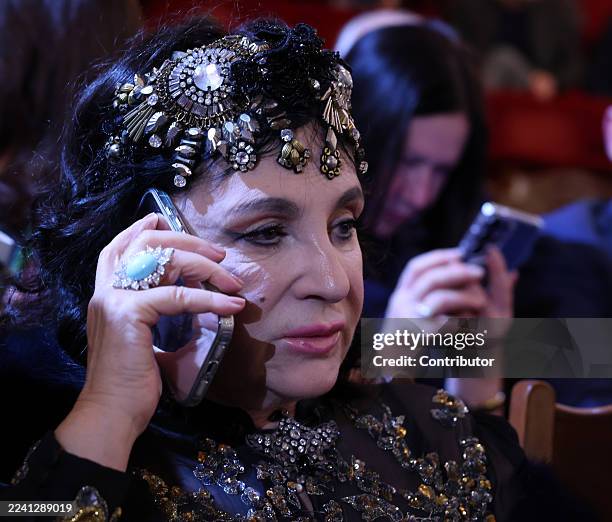 Russian rhythmic gymnastic coach Irina Viner speaks on her phone prior to a concert, marking the 20th Anniversary of RT Channel at Bolshoi Theater on...