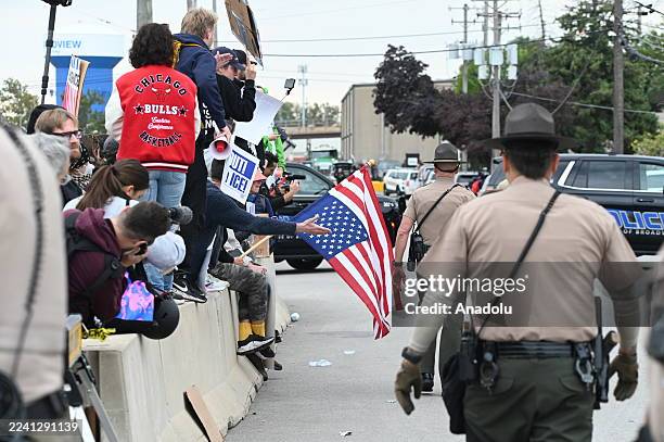 Police detain a protestor as people gather to stage a rally in front of the ICE building after the recent dismantling of the facility's security...