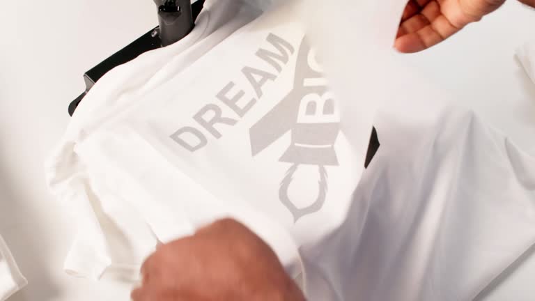 https://media.gettyimages.com/id/2241391923/video/custom-t-shirt-printing-heat-press.jpg?b=1&s=640x640&k=20&c=LsqM3c7G7qMfjGshL4sr4GIlM2emgI0Ax1DTRX6N_DU=