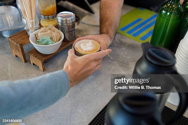 customer receiving coffee from barista - latte barista stock pictures, royalty-free photos & images