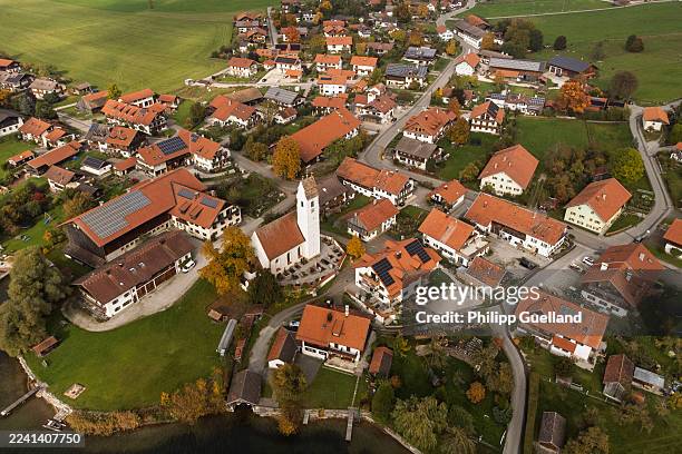In this aerial view taken with a drone solar panels lie installed on roofs of residential houses on October 16, 2025 in Riegsee, Germany. The state...