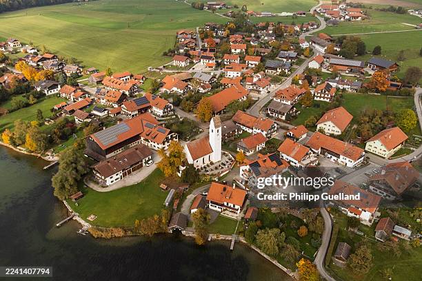 In this aerial view taken with a drone solar panels lie installed on roofs of residential houses on October 16, 2025 in Riegsee, Germany. The state...