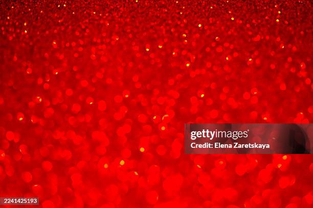 vibrant red glitter background with bokeh lights for festive party and glamour projects - iluminación gobo fotografías e imágenes de stock