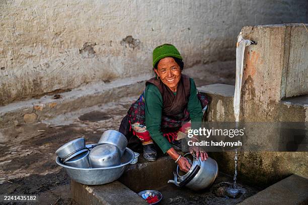 tibetan woman washing dishes. mustang - nepal people stock pictures, royalty-free photos & images