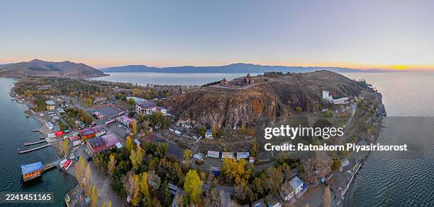 the historic 9th-century sevanavank monastery, an iconic landmark on the shores of lake sevan, armenia, is silhouetted against a spectacular golden sunrise. - sevanavank monastery stock pictures, royalty-free photos & images