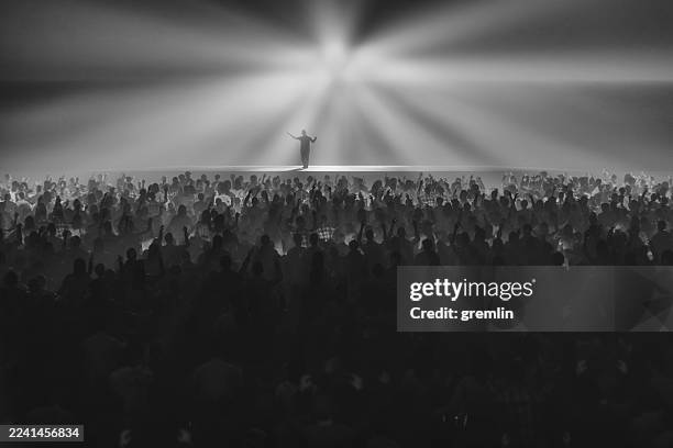 ecstatic crowds of people with man on the stage - concert crowd stock pictures, royalty-free photos & images