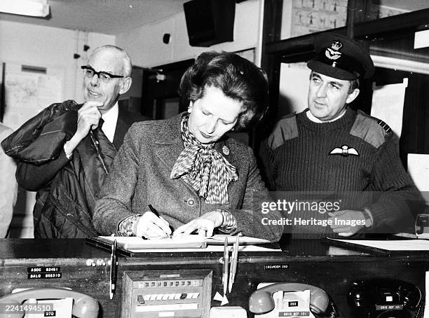 Margaret and Denis Thatcher on a visit to Northern Ireland, 23 December 1982. Britain's first female prime minister and her husband with military...