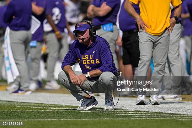 Head Coach Brian Kelly of the LSU Tigers squats on the sideline in the second half against the Vanderbilt Commodores at FirstBank Stadium on October...