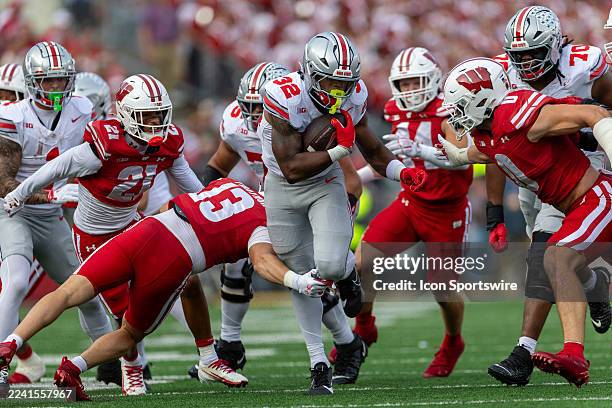 The Ohio State Buckeyes running back Isaiah West breaks though the arm tackle attempt of Wisconsin Badgers safety Matthew Traynor durning a college...