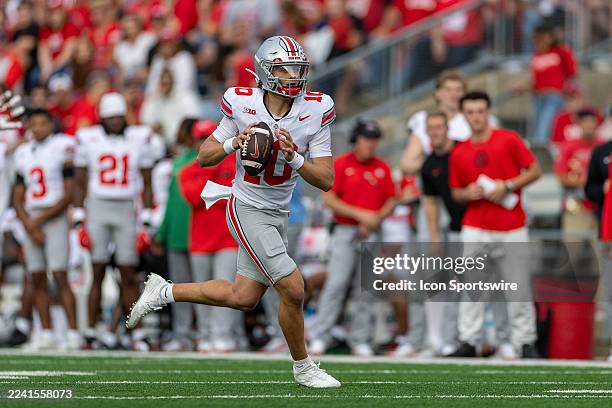 The Ohio State Buckeyes quarterback Julian Sayin scrambles looking to pass the football durning a college football game between The Ohio State...