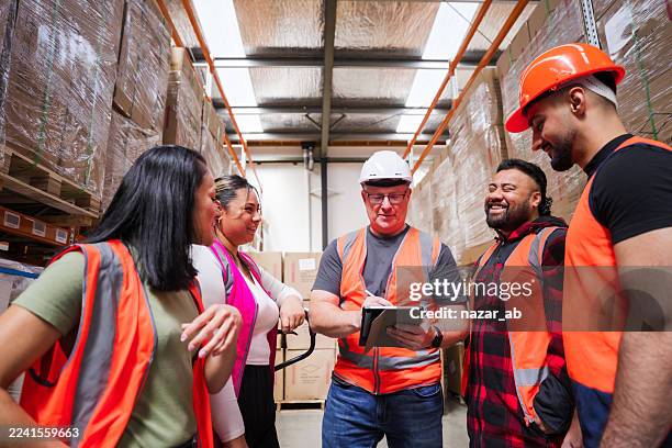 team of warehouse professionals using tablet for inventory control. - supply and demand stock pictures, royalty-free photos & images