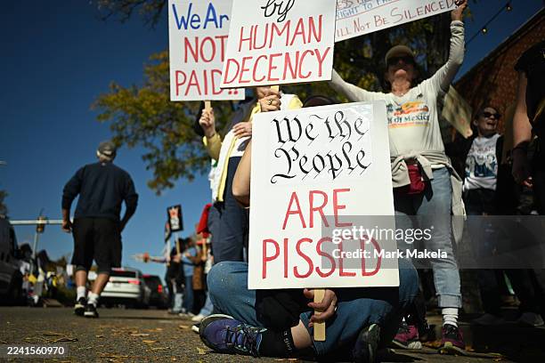 Protestors demonstrate during the "No Kings" protest on October 18, 2025 in Longmont, Colorado. Organizers expect millions to participate in cities...