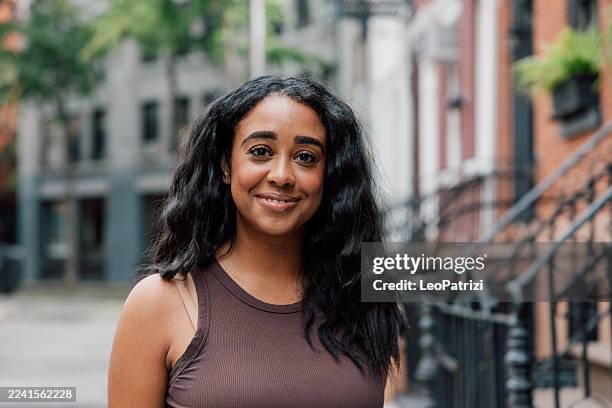 lifestyle portrait of a woman enjoying time outdoors in a quiet neighborhood - west village stock pictures, royalty-free photos & images